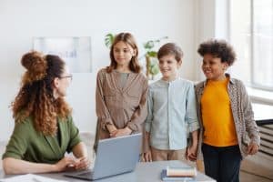 Kids Talking to Teacher in School